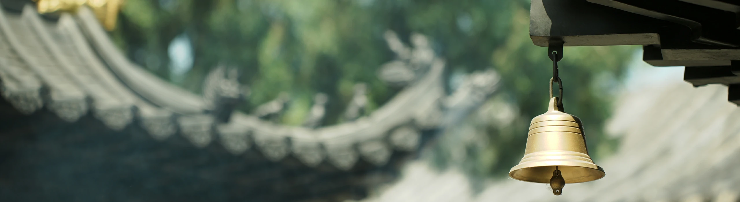 Temple bell and traditional roof detail for Taoist blessing ritual banner
