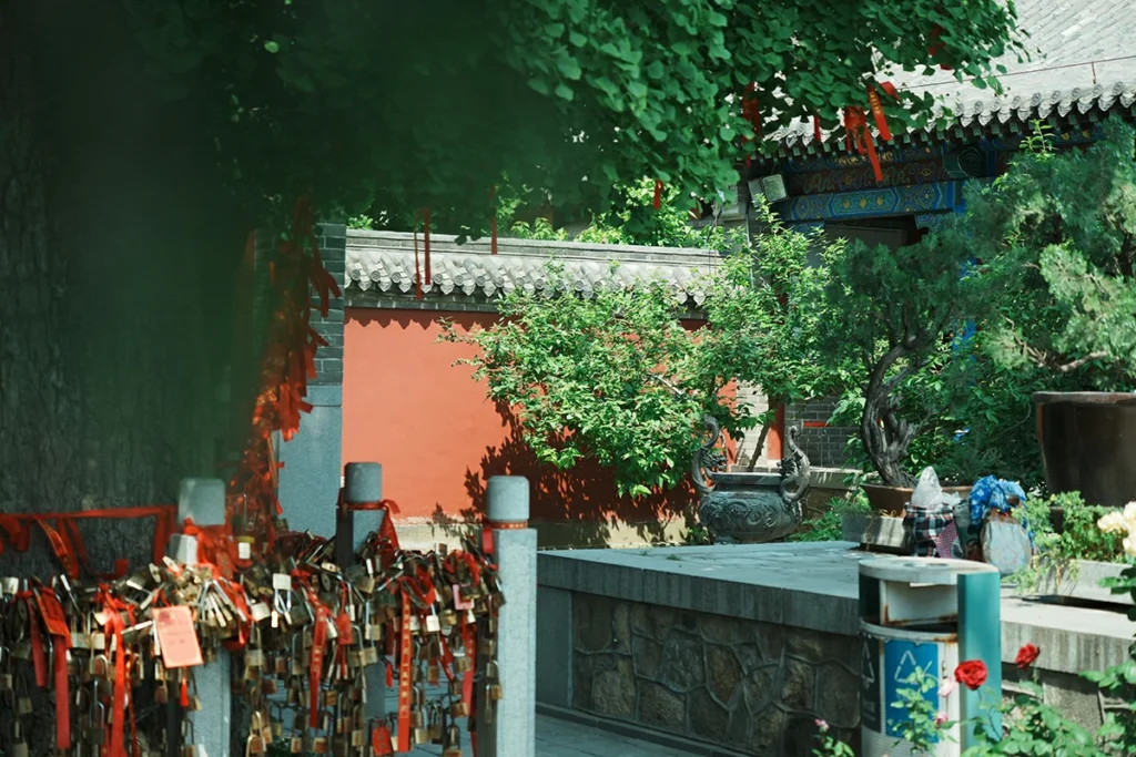Open red temple doors with trees for spiritual service entrance