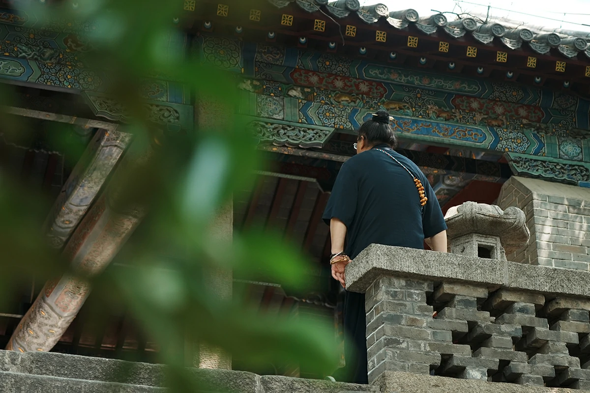 Visitor at Taoist temple railing for private service confirmation process