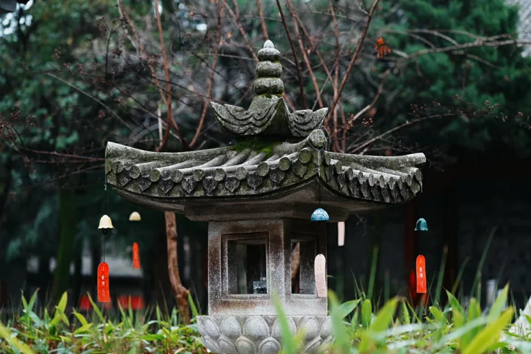 Small Taoist pavilion with offering lamps in temple garden
